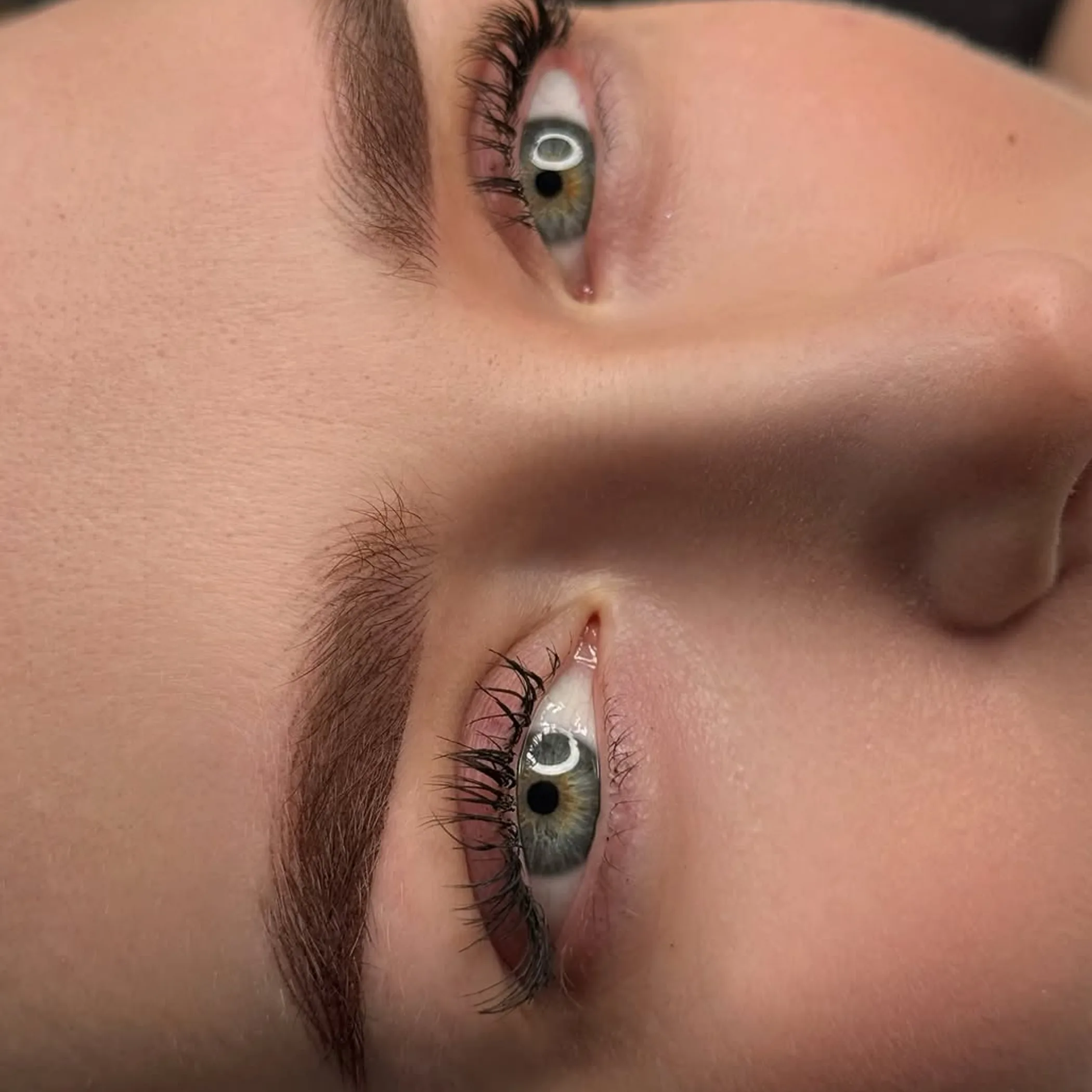 professional eyebrow artist applying pigment shading